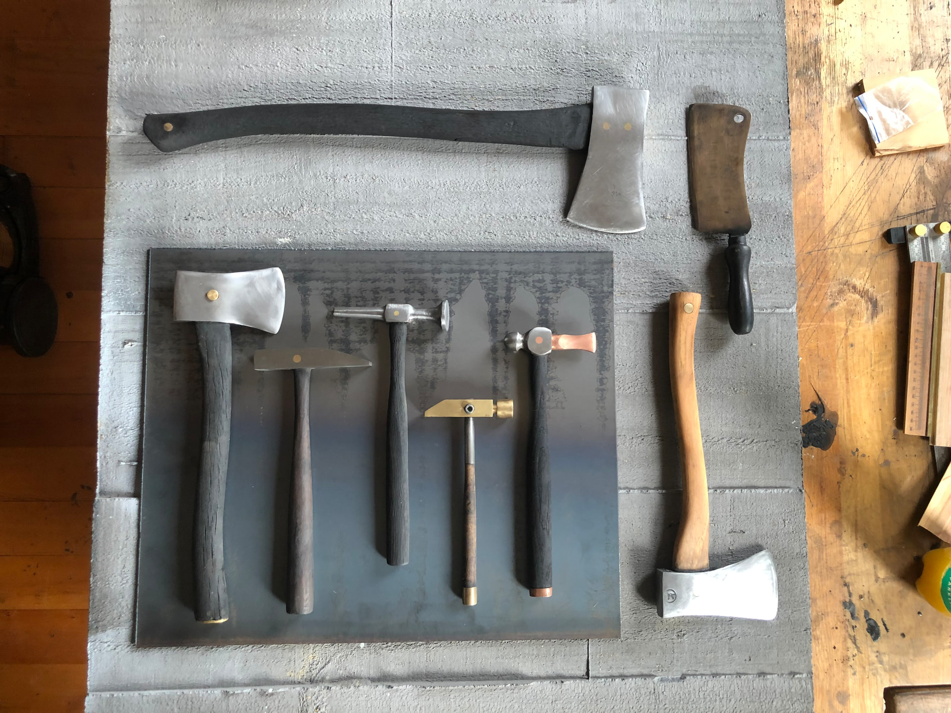 Collection of handmade axes and hammers in the workshop