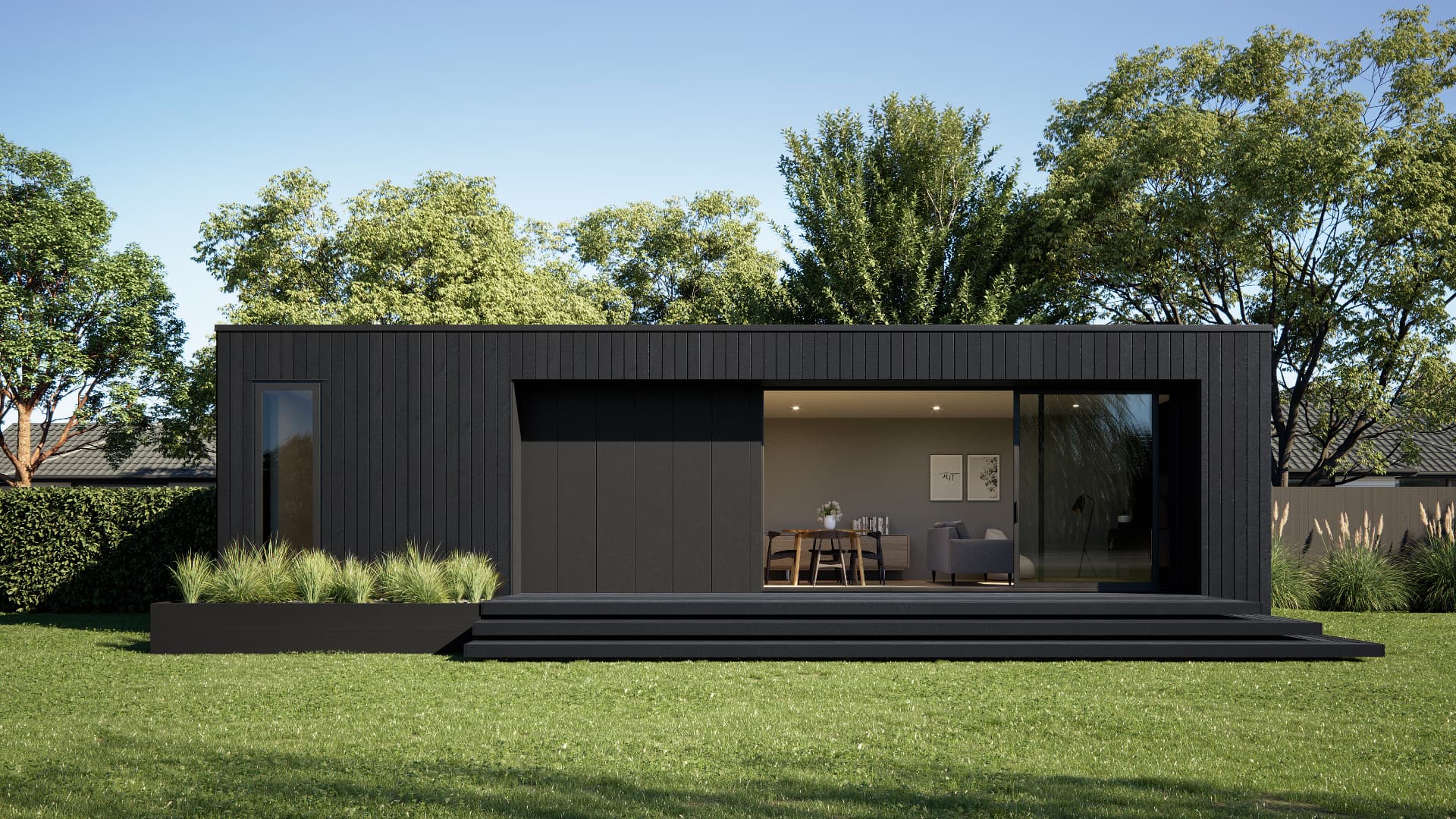 Single-storey dark-clad modular dwelling with a recessed terrace overlooking a lawn